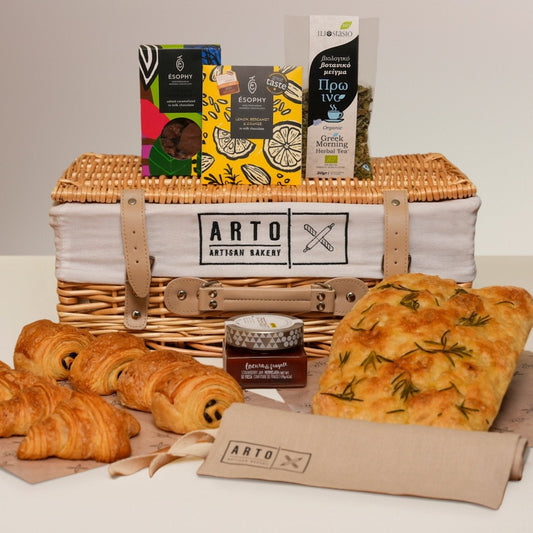 Artisan bread and pastries in a basket with 'ARTO Artisan Bakery' branding.